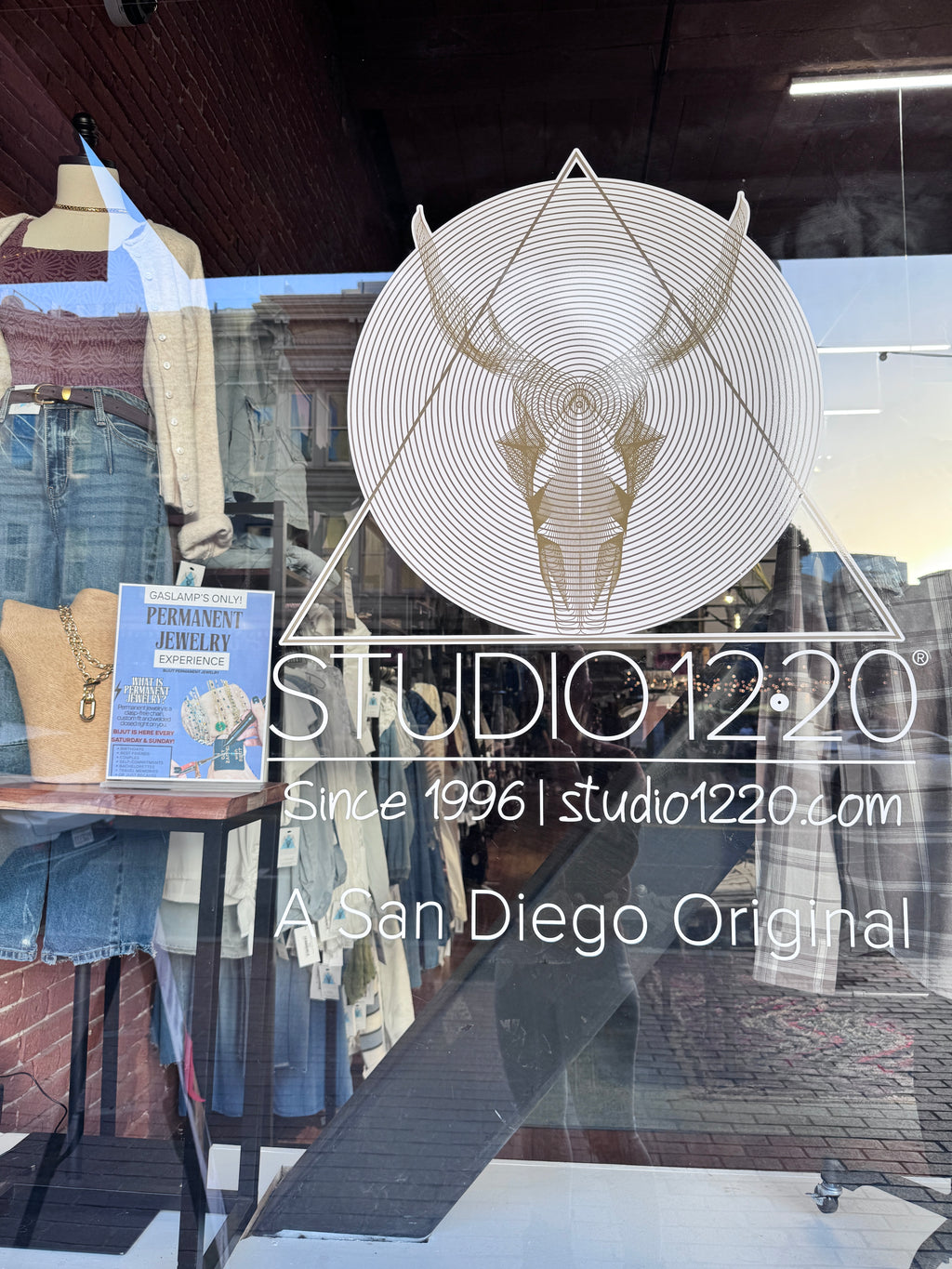 Decorative wall art with geometric design on a glass surface, featuring 'Studio 1220' branding.