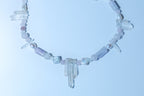 Necklace with crystal beads on a light blue background