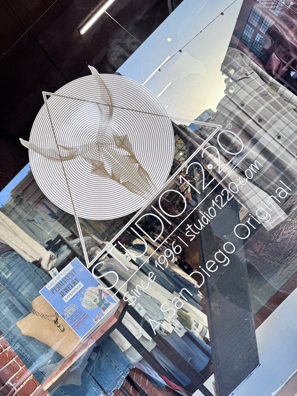 Glass table with decorative plate and cityscape reflection