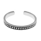 Silver toe ring with bead detailing on a white background