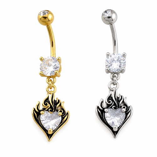 Two belly button rings shown side by side on a white background. The left ring is gold-toned with a heart-shaped flame pendant featuring a clear heart-shaped gemstone.