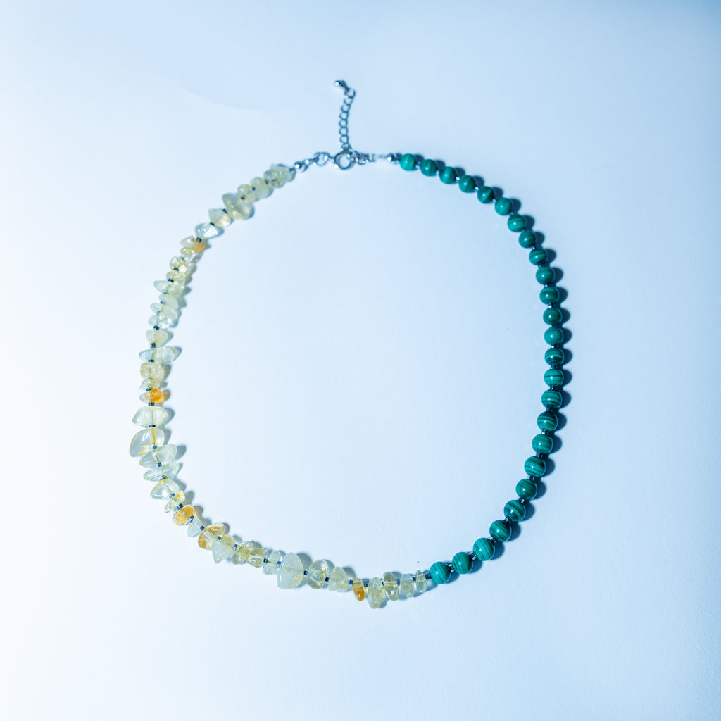 Beaded necklace with blue and multicolored beads on a light blue background