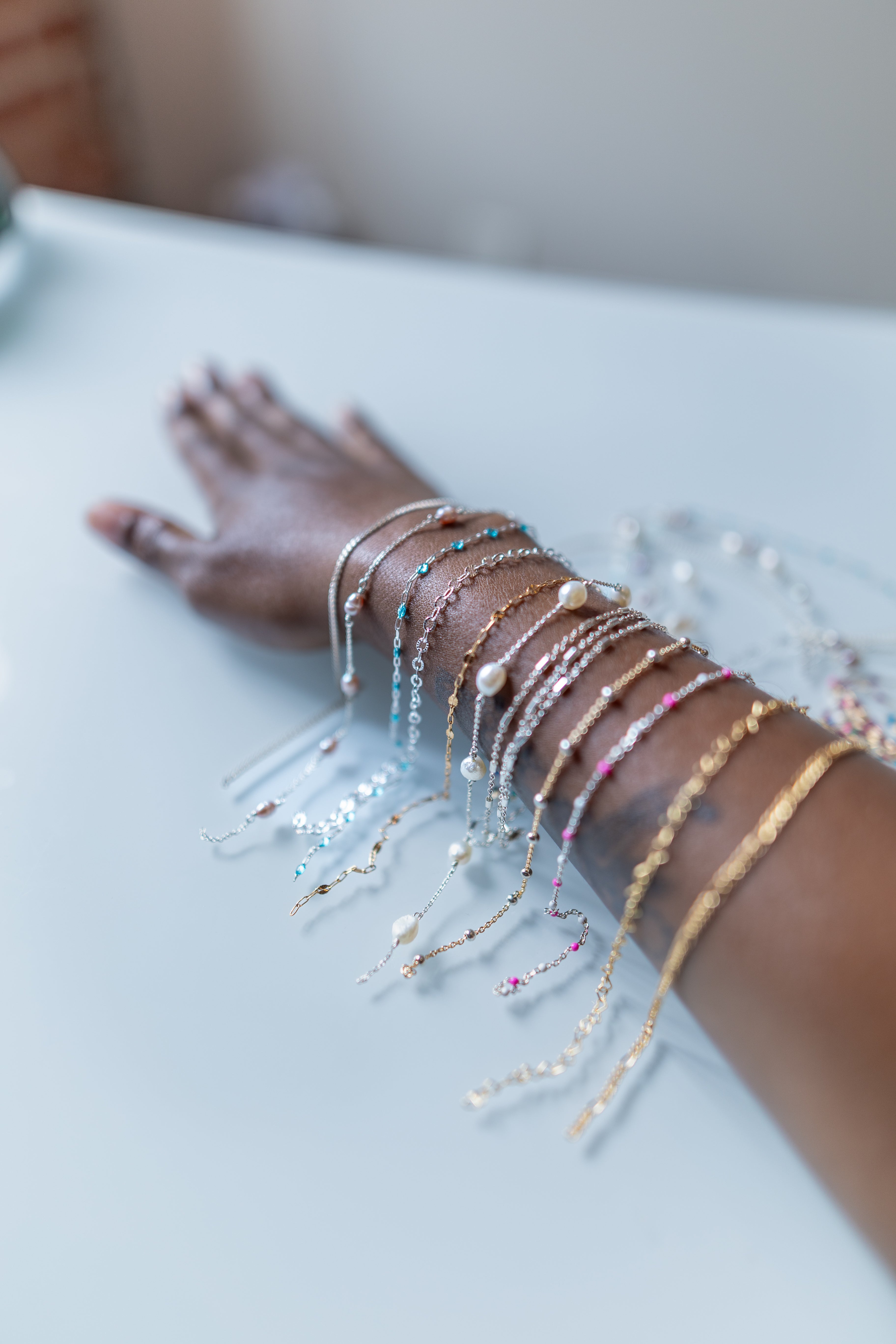 arm with permanent jewelry chains