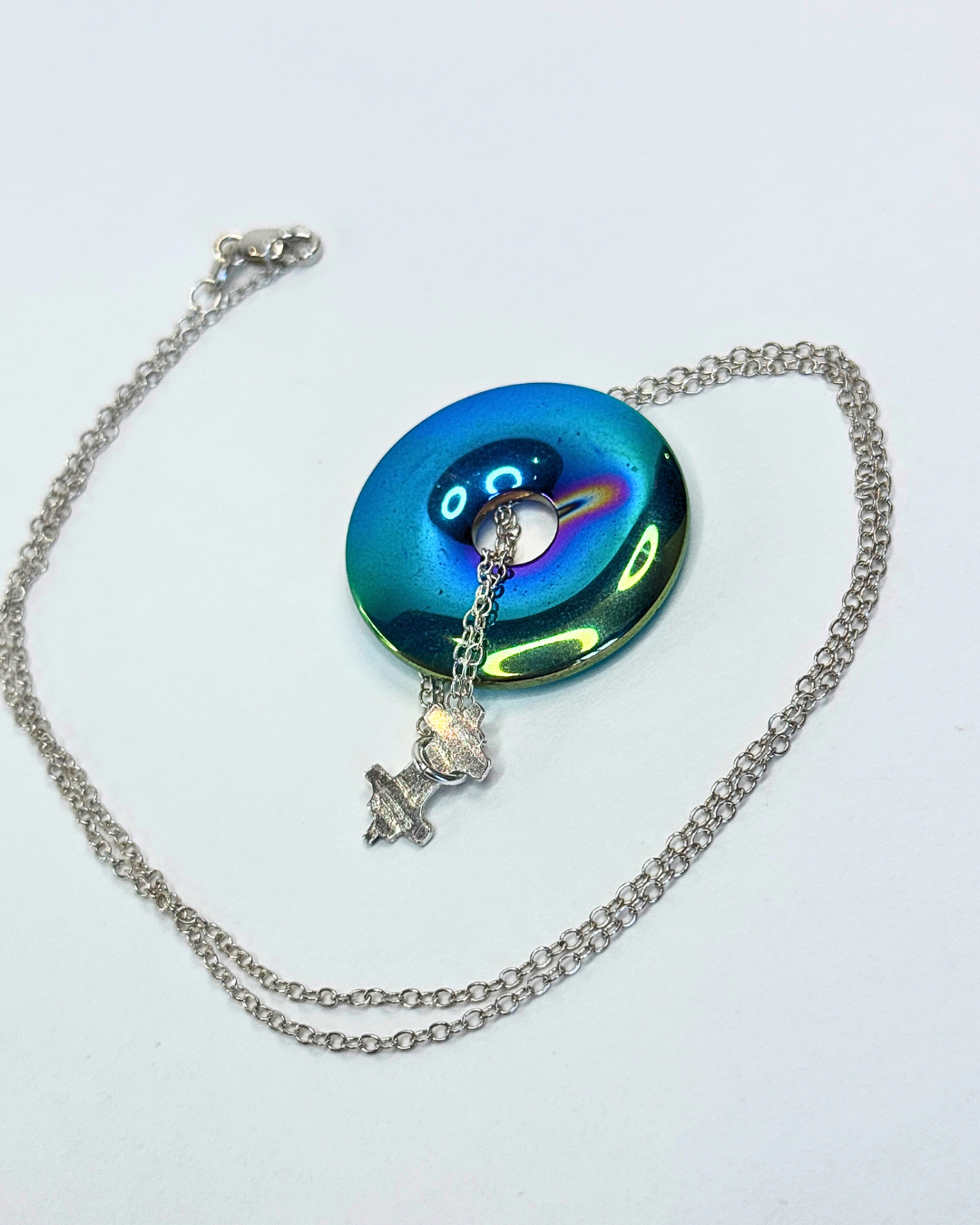 Necklace with a colorful pendant on a white background