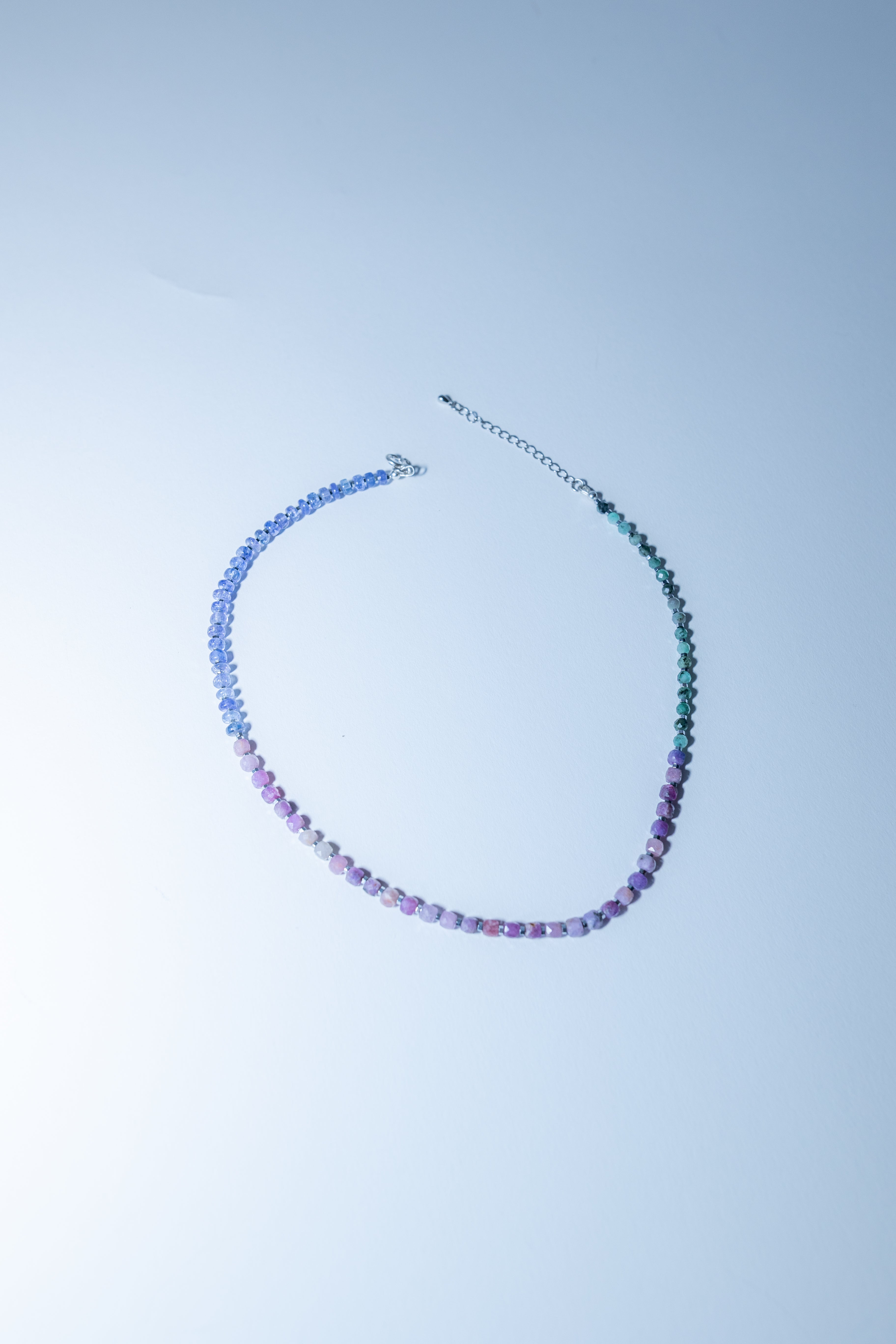 Necklace with multicolored beads on a light blue background