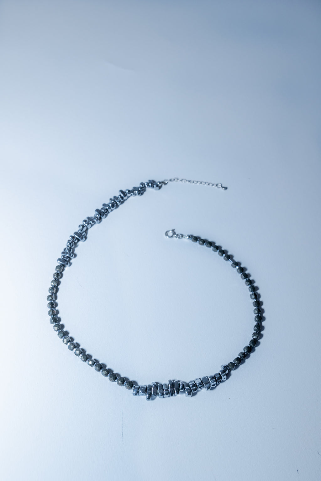 Necklace with blue beads on a light gray background