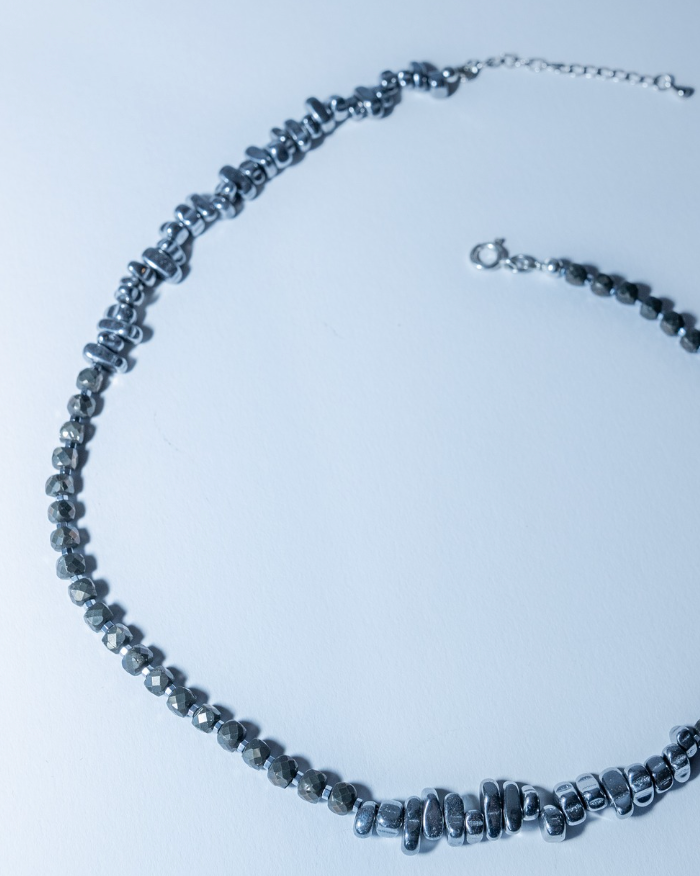 Necklace with black beads on a light blue background