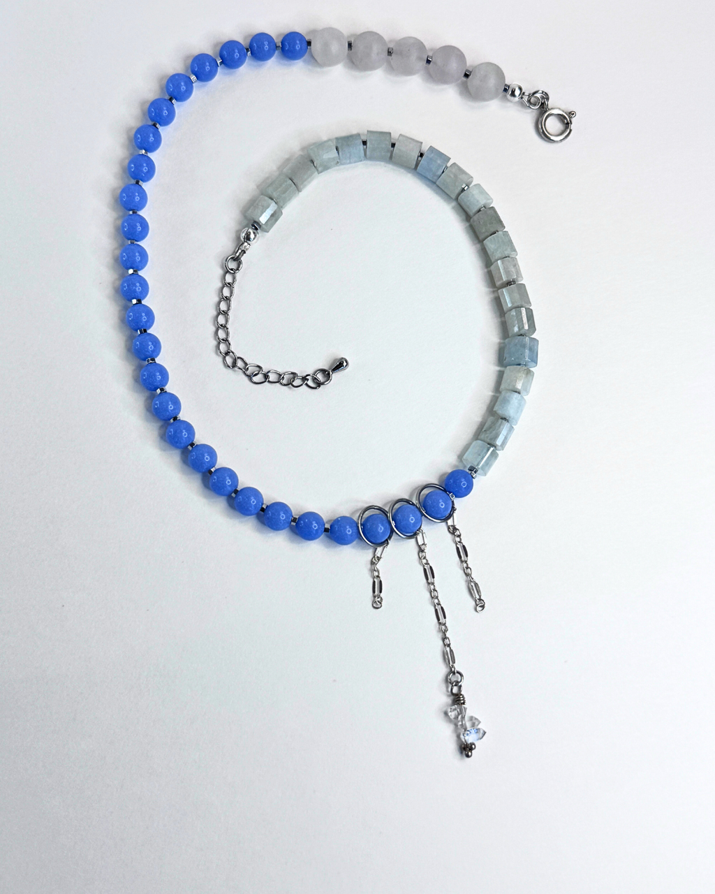 Necklace with blue and gray beads on a white background