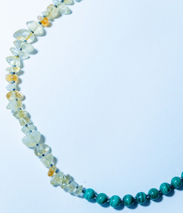 Necklace with multicolored beads on a light blue background