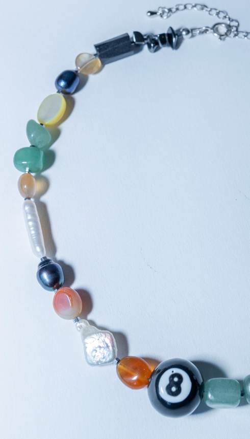 Necklace with multicolored beads and a silver clasp on a white background