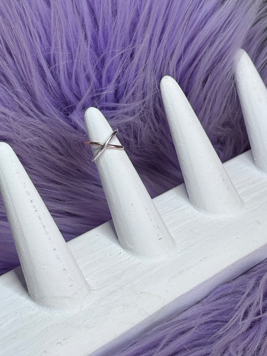 White glove with a ring on a purple fur background
