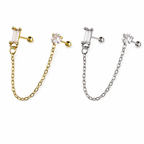 Two matching ear cuff earrings with chain links, shown side by side on a plain white background. The left earring is gold-toned with a clear baguette stone and a round clear stone, while the right earring is silver-toned with the same clear stones.