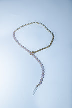Necklace with clear pendant on a light blue background