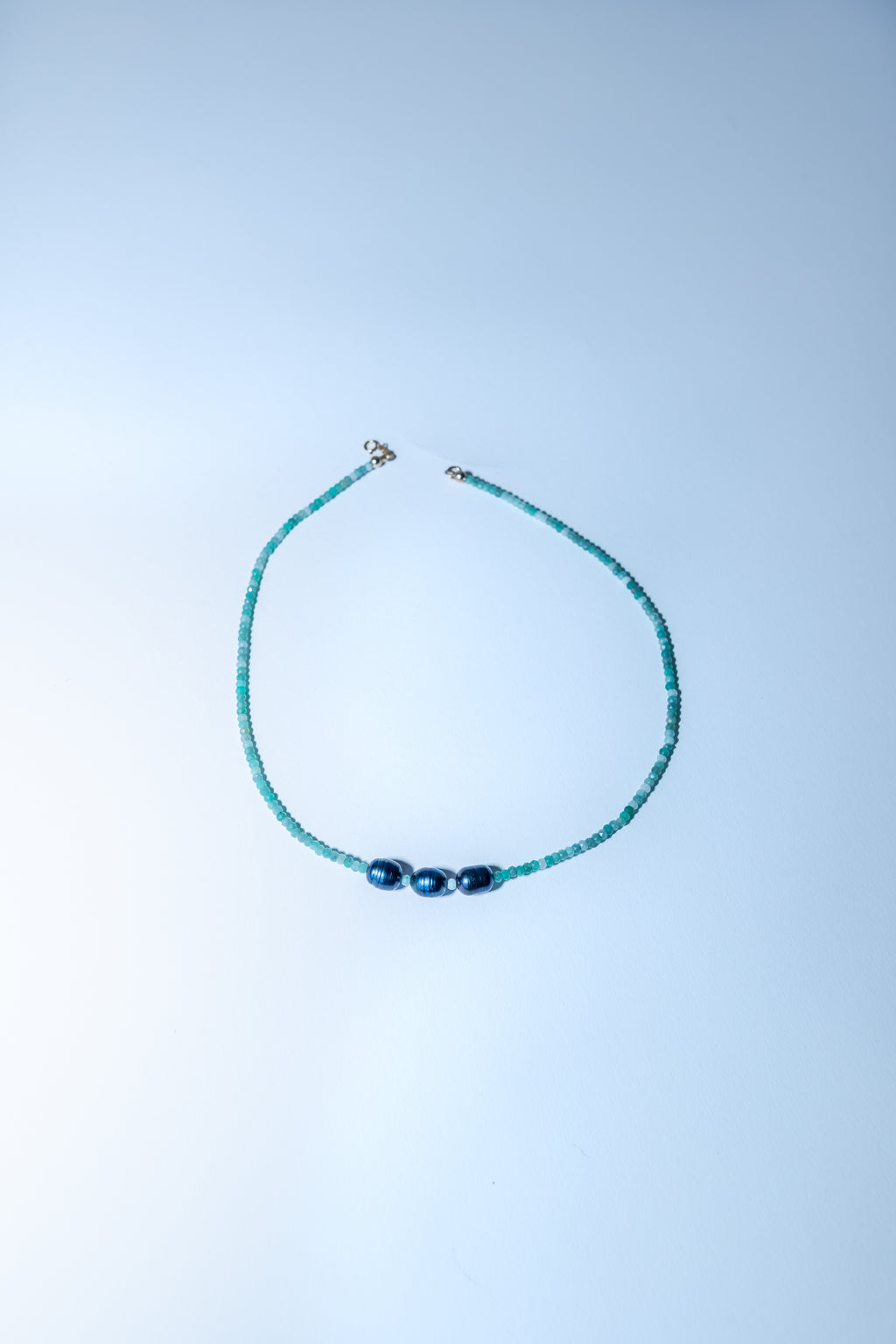Beaded necklace on a light blue background