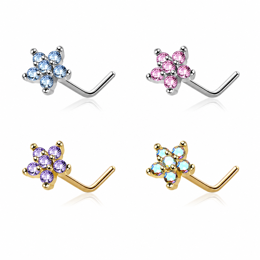 Four flower-shaped nose studs arranged in a 2x2 grid on a white background. The top-left pair has light blue stones in silver settings, the top-right has pink stones in silver settings, the bottom-left has purple stones in gold settings, and the bottom-right has iridescent light blue stones in gold settings.