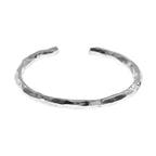 Silver toe ring with a textured finish on a white background