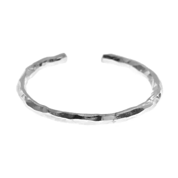 Silver toe ring with a textured finish on a white background