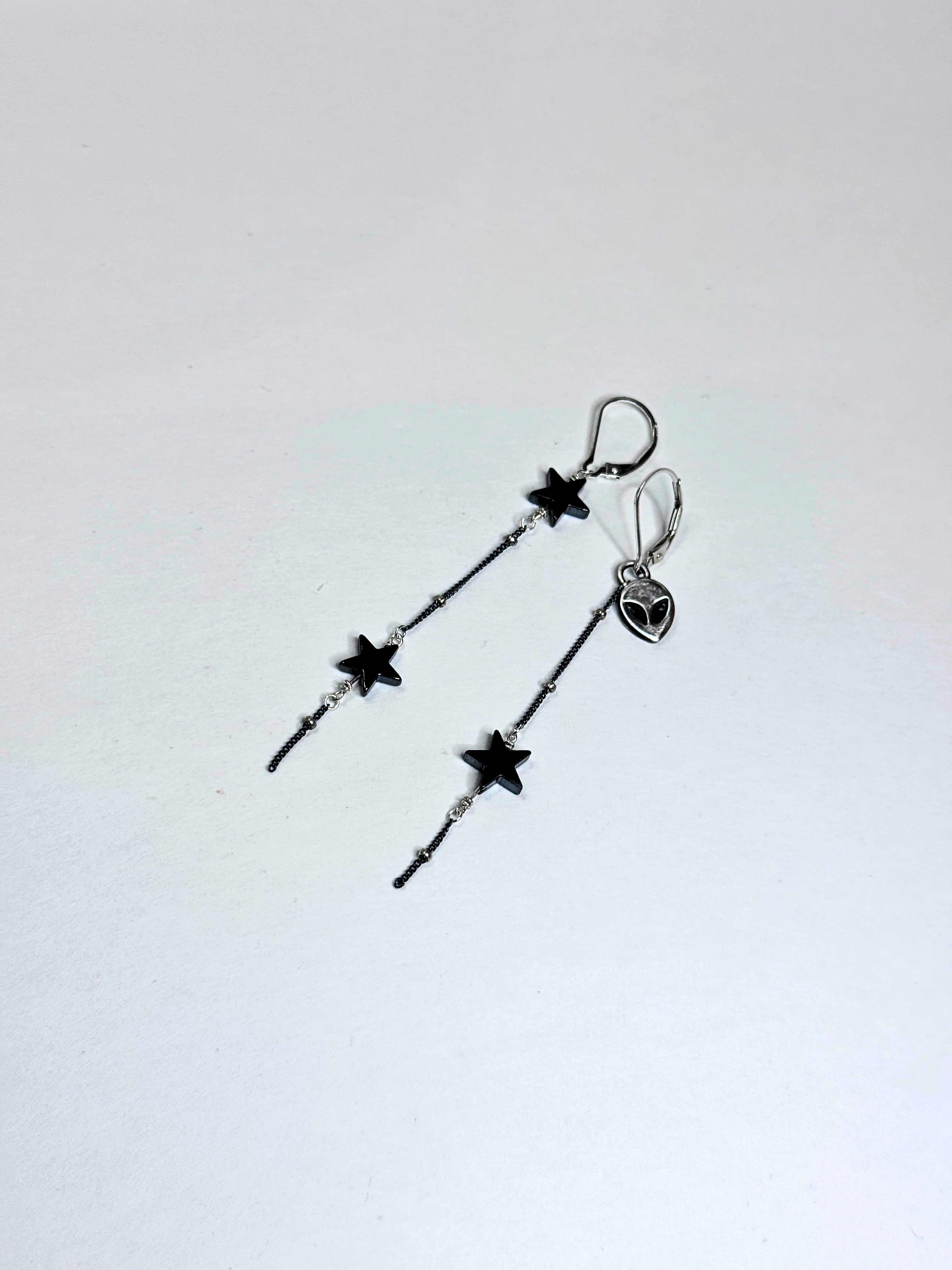 Star-shaped earrings on a light gray background