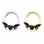Two small hoop-style body jewelry pieces with bat-wing charms and black heart-shaped stones, shown side by side on a plain white background. One is silver-toned and one is gold-toned. Hinged Septum piercings