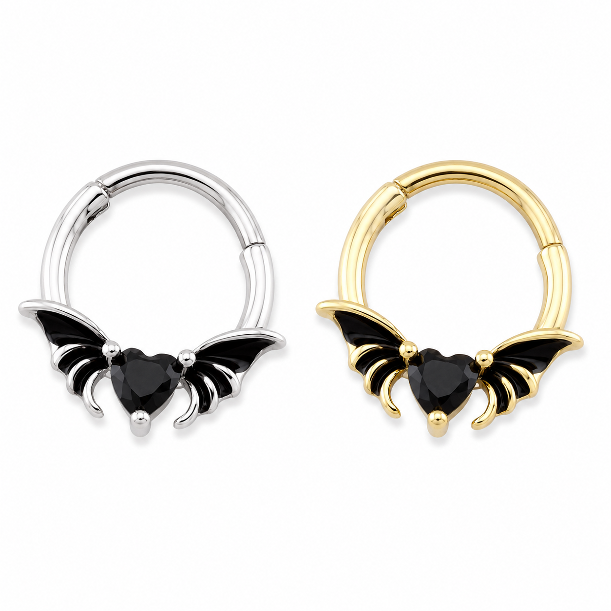 Two small hoop-style body jewelry pieces with bat-wing charms and black heart-shaped stones, shown side by side on a plain white background. One is silver-toned and one is gold-toned. Hinged Septum piercings
