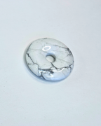 Marble-patterned donut-shaped object on a light gray background