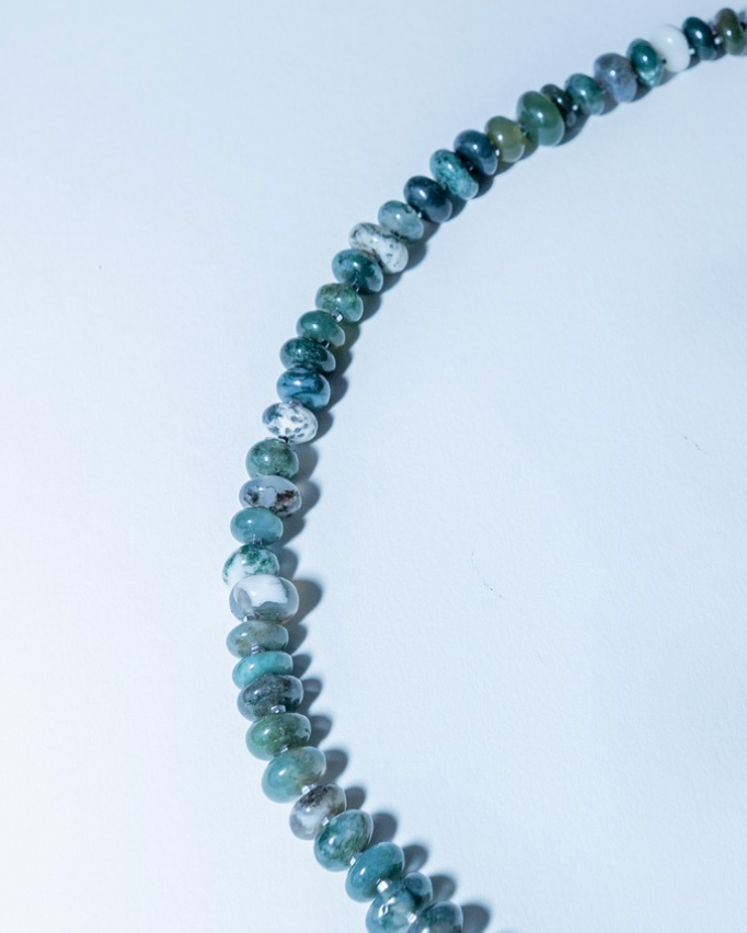 Necklace with blue and green beaded chain on a white background