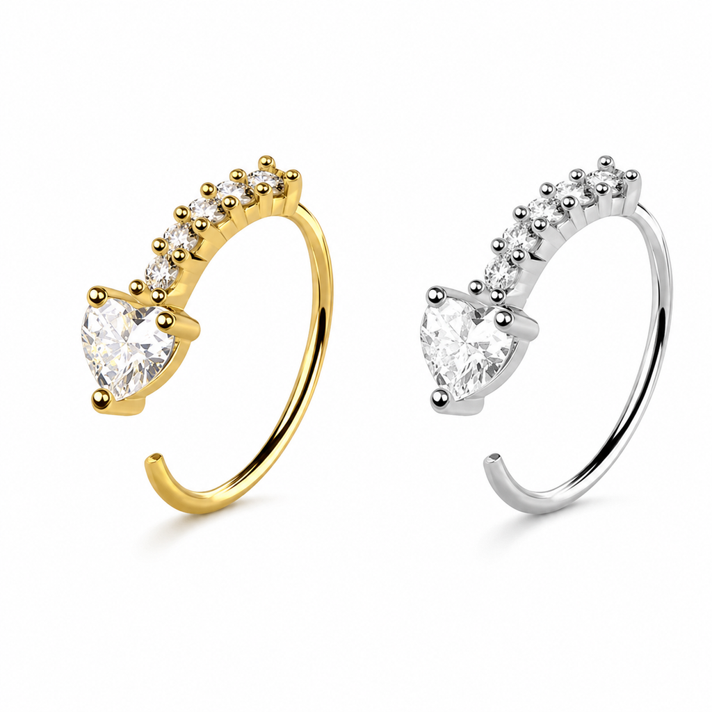 Two open hoop-style hoop earrings shown on a white background, one in yellow gold and one in silver, each featuring a large heart-shaped clear gemstone and smaller round stones along the top curve.