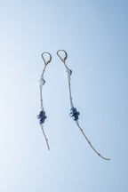 Pair of beaded earrings on a light blue background
