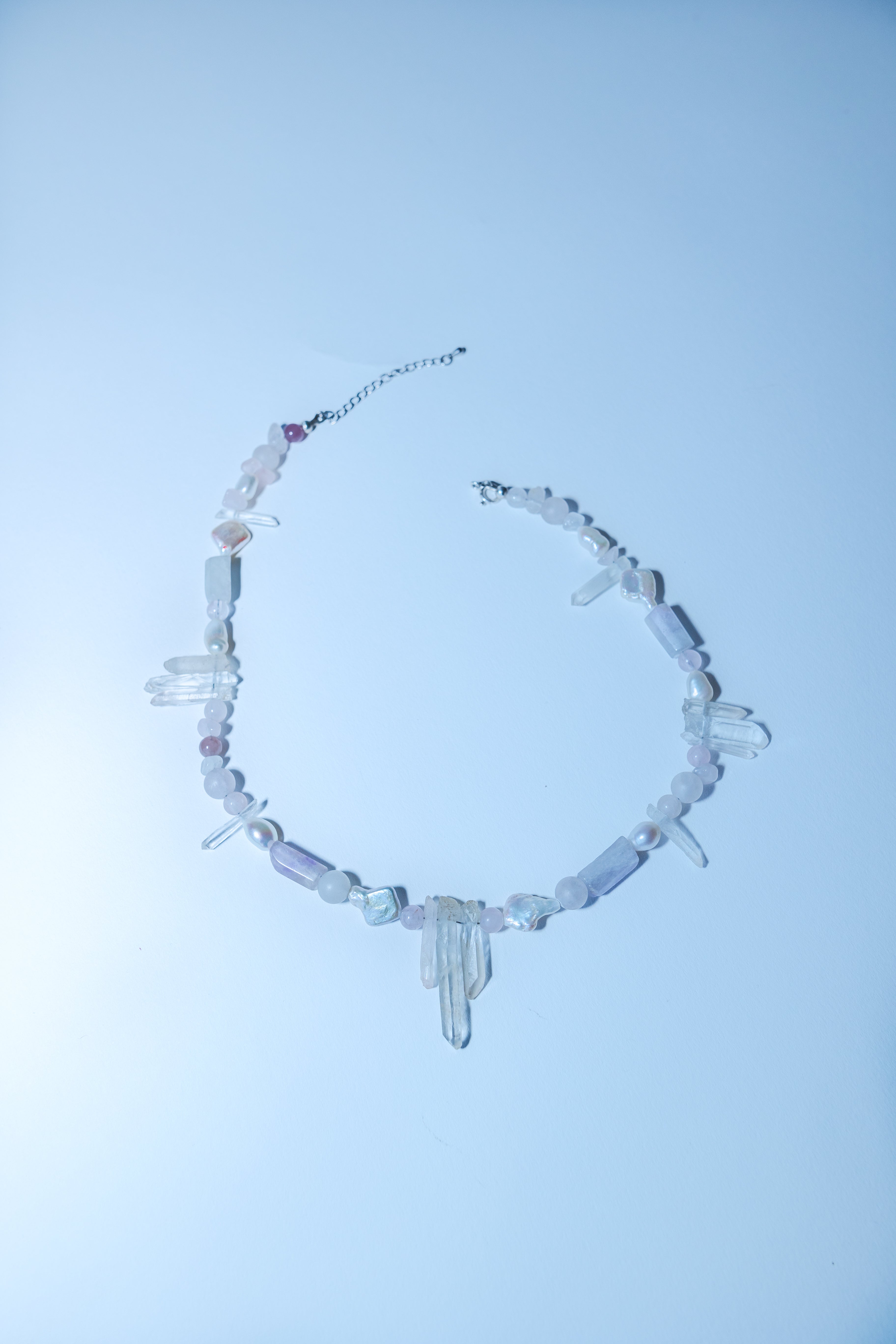 Crystal necklace on a light blue background