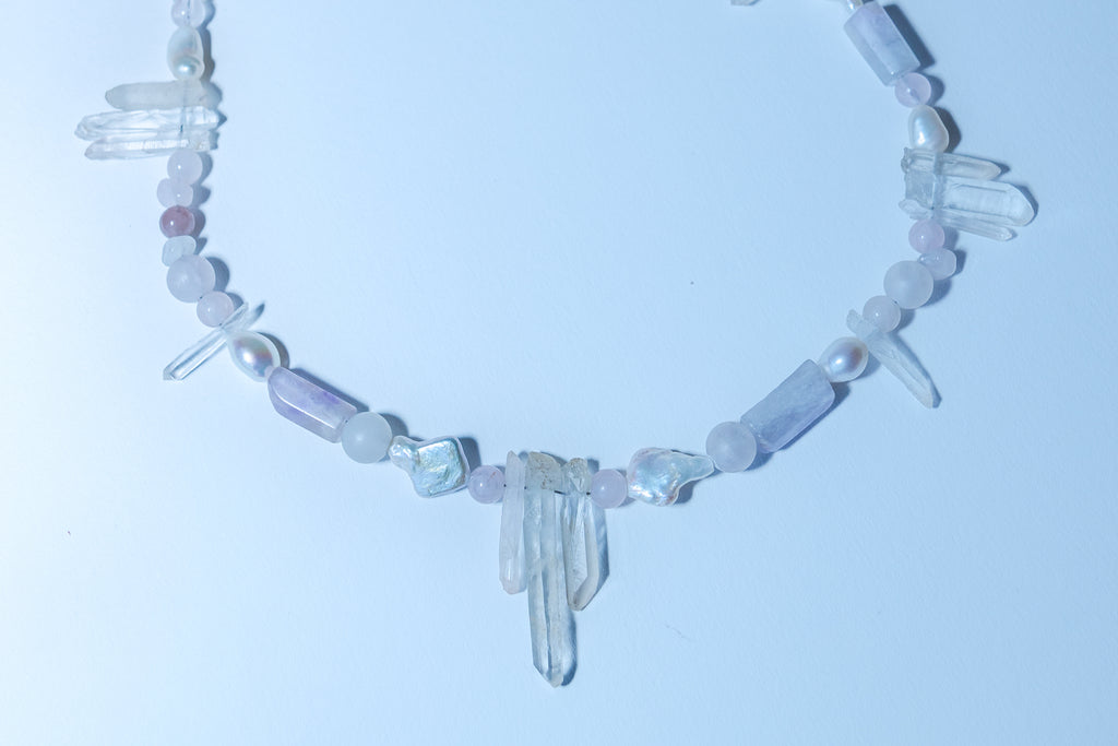 Necklace with crystal beads on a light blue background