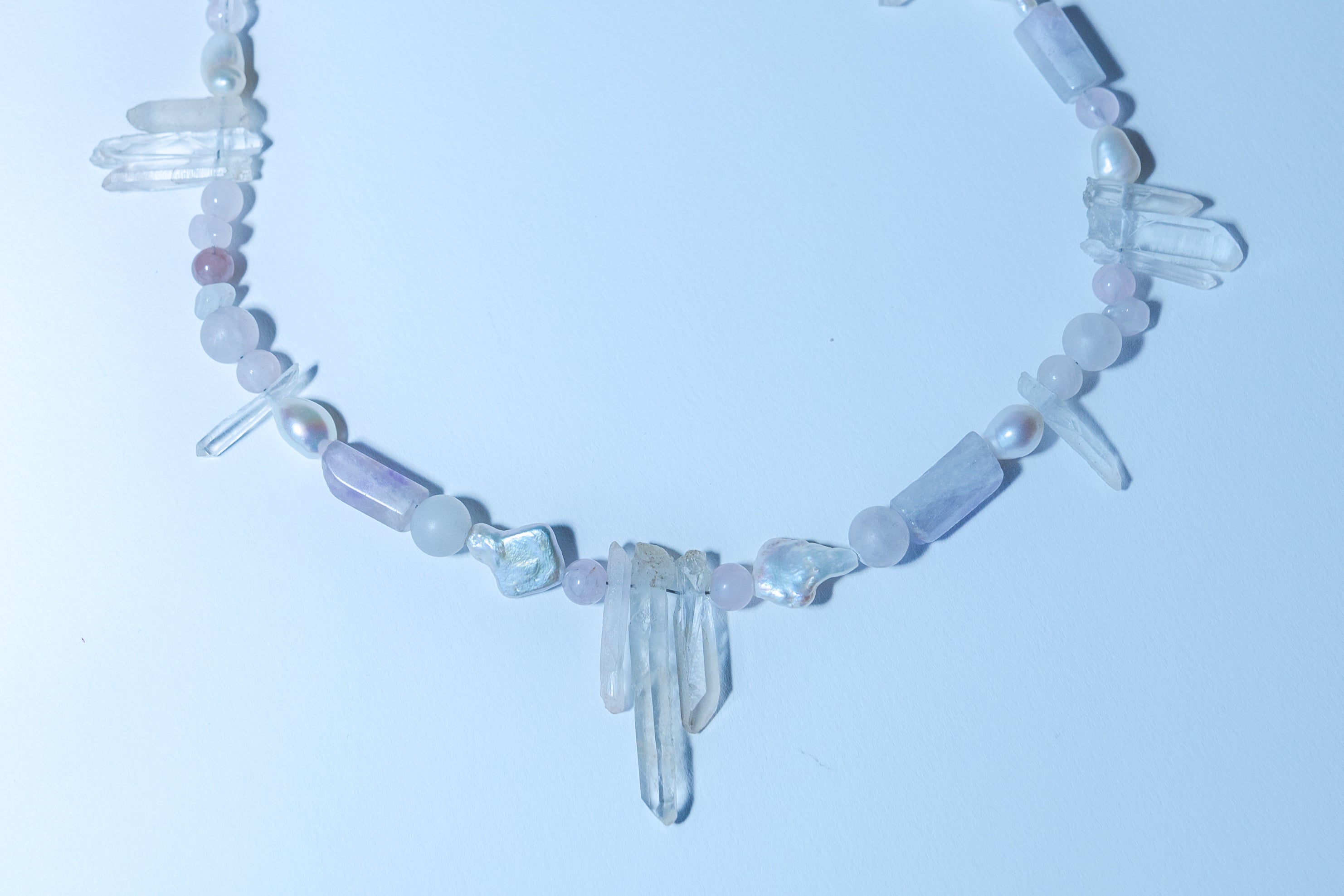 Necklace with crystal beads on a light blue background