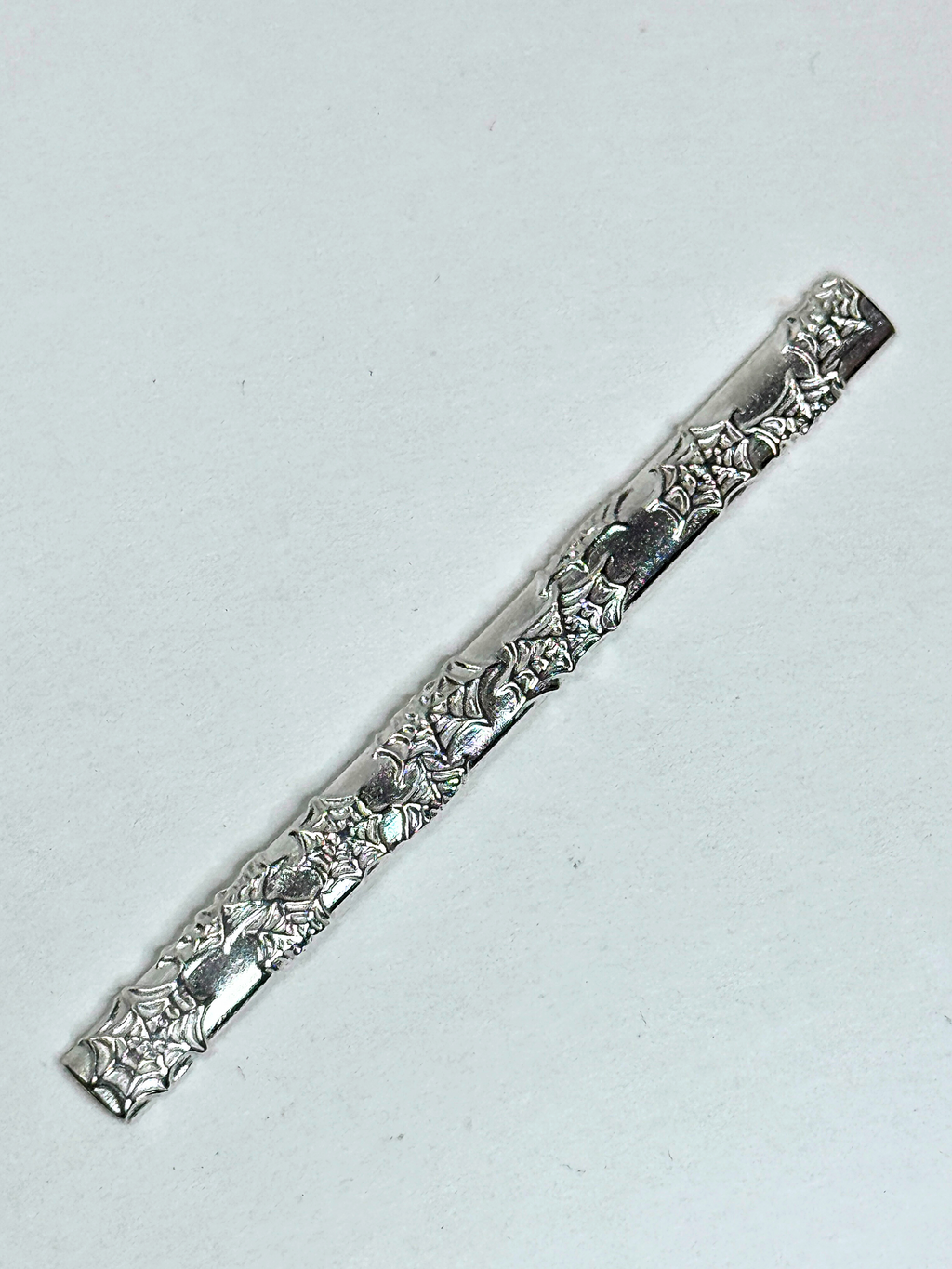 Decorative silver bar on a light gray background