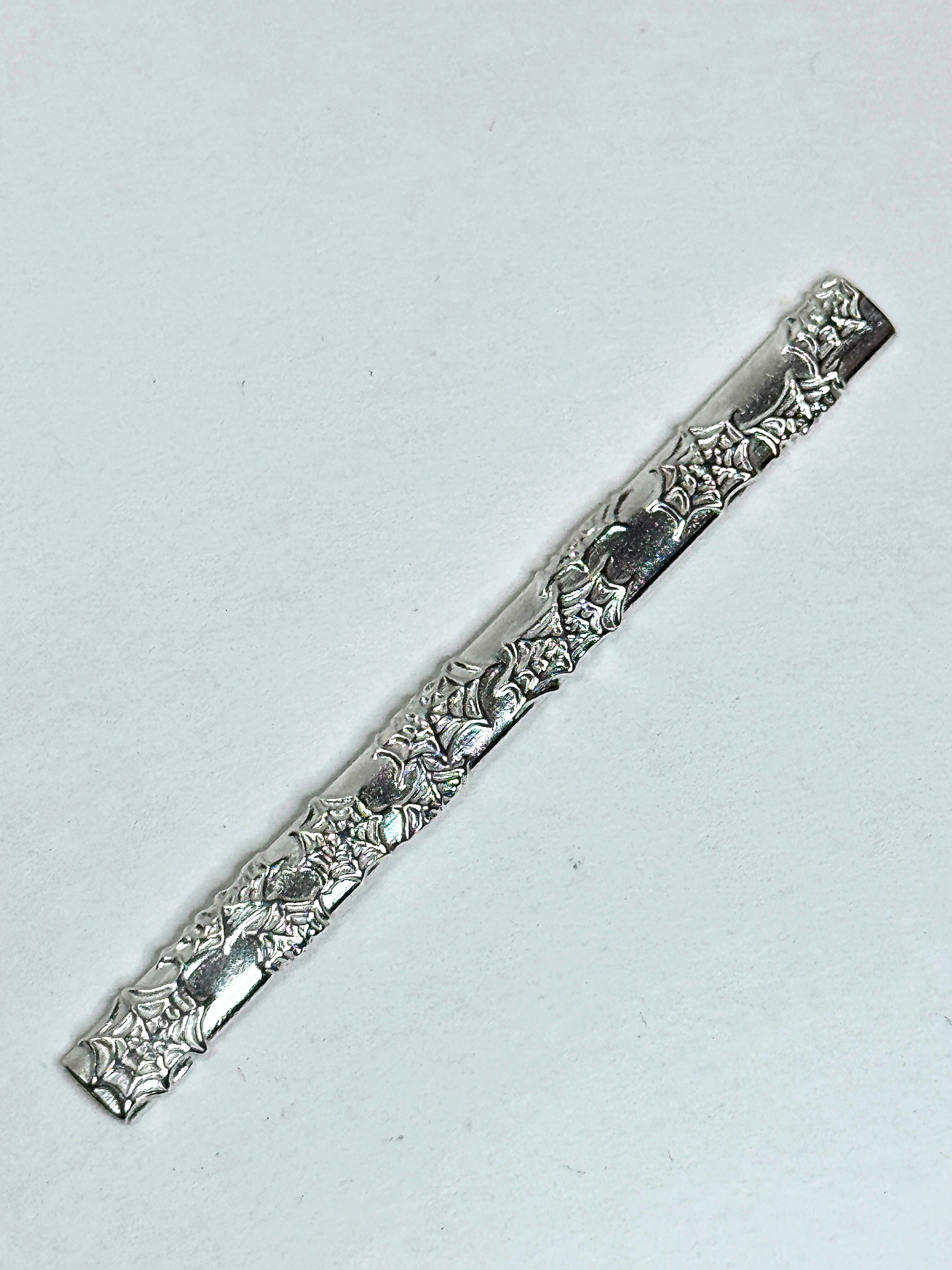 Decorative silver bar on a light gray background