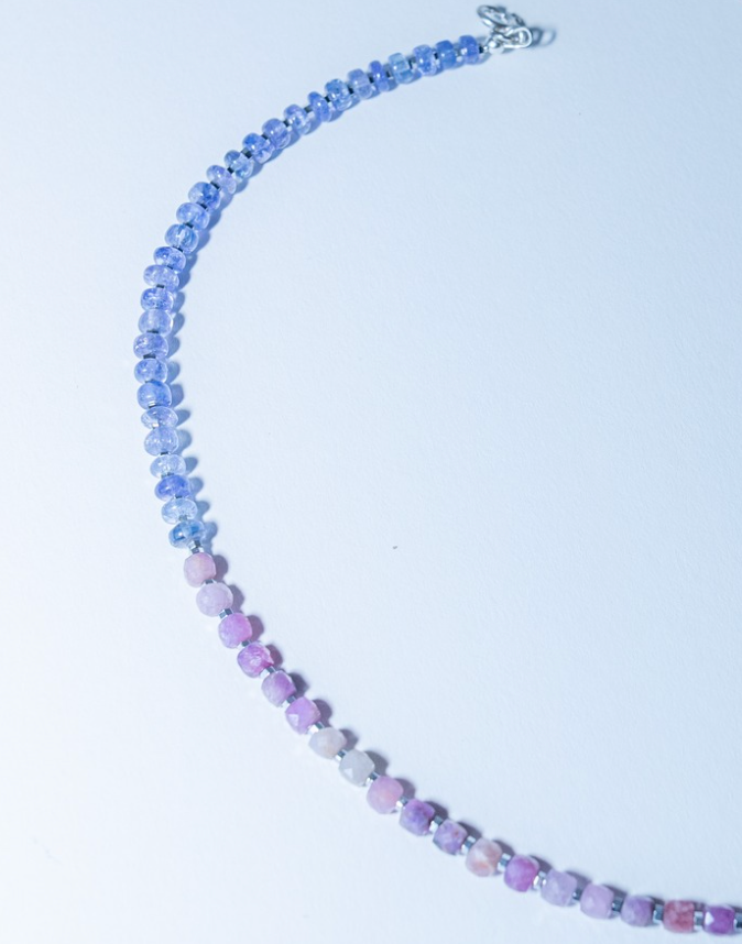 Necklace with multicolored beads on a light purple background