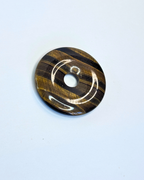 Decorative circular object with concentric patterns on a light blue background